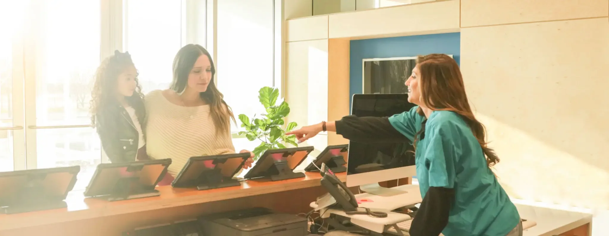 Front desk staff welcoming patients at Lake Medical and Chiropractic Center